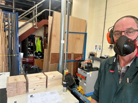 Technician cutting wood